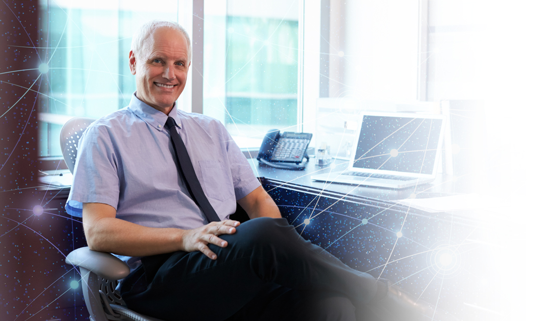 Man sitting at desk with laptop